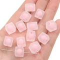 Hand holding a square pink macrame acrylic bead with a matte translucent finish - 10Pcs/Pack / Matte Pink