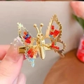 Fermaglio per capelli a farfalla dorata con perle colorate mostrato in primo piano - Oro con Perline