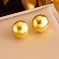 Macro shot of polished gold-plated stainless steel ball stud earrings on a jewelry display - Gold Ball Stud Earrings (E5850)
