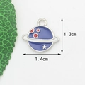 Macro shot of a 1.4cm blue planet charm made of zinc alloy with red dots and stars - White K Purple Planet
