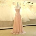 Pink chiffon evening dress with lace floral applique on a mannequin in a bridal shop - US 2(S) / Pink