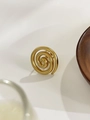 Macro view of a gold-plated spiral ring with polished finish on a wooden display - US 8 / Mosquito Coil Spiral Style
