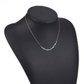 Bohemian gold chain necklace featuring light blue beads and white pearls on a black display - Light Blue Faceted Beads with Pearl