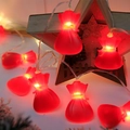 Close-up of red lucky bag LED string lights with warm glow for holiday decoration - Christmas Lucky Bag
