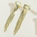 Detail of long golden heart tassel earrings featuring a brushed texture and metallic chains - 14K Gold Heart Tassel / Gold