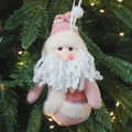 Pink plush Santa Claus hanging ornament with white beard on a Christmas tree - Pink Santa Claus