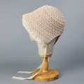 Detail view of beige crochet baby sun hat featuring intricate white lace trim and ties - M (56-58cm) / Beige