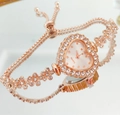 Macro view of rose gold heart-shaped quartz watch with crystal flowers and adjustable strap - Rose Gold White
