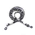 Close-up of black and white woven eyewear strap with silver metal sleeves and rubber loops - Style 6/Black & White
