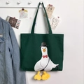 Detail of dark green canvas tote featuring cartoon duck with 3D plush webbed feet - Cane Duck Green