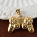 Detail view of a 24K gold-plated game controller pendant on a soft brown velvet surface - Gamepad - Gold