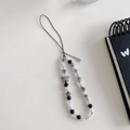 Detail of beaded phone strap featuring a silver Good Luck tag and colorful butterfly charms - Cracked Beads Square Pendant