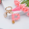 Pink resin letter P keychain with gold foil flakes, pink tassel, and gold lobster clasp - Letter P