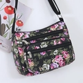 Women floral nylon crossbody bag in black with pink flowers and multiple pockets - Black