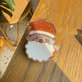 Sparkly Santa Claus hair accessory with glitter resin on a sunny wooden background - Santa Claus