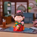 Cute Tang Dynasty lady figurine in red and green Hanfu holding a flower basket - Stroll Among Flowers (Large) / 【product Attributes】q-version Chinese Traditional Costume Doll Figurine. The Doll Wears A Red And Green Hanfu (traditional Han Clothing) Adorned With Gold Patterns. It Wears A Pink Peony Hair Ornament And Its Eyes Are Closed In A Smiling Gesture. Its Right Hand Holds A Bamboo Basket Filled With Pink Flowers And Its Left Hand Holds A Single Bouquet. The Material Appears To Be Fine Resin With A Matte Finish. 【visual Presentation】the Image Is Staged With A Miniature Antique-style Chinese Study As The Background Including A Screen Display Shelves And The Four Treasures Of The Study (writing Brush Ink Stick Inkstone And Paper). The Background Uses A Shallow Depth-of-field Blurring Technique Making The Main Figure Stand Out. Image Quality Is [high] With Accurate Exposure And Rich Colors Creating A Warm And Harmonious Overall Atmosphere. Aesthetic Appeal Is [high] With An Overall Score Of [8.8]. The Props And Product Have A Very High Level Of Matching Quality. 【text Content】the Image Does Not Contain Any Product_text Watermarks Or Other Layered Text. 【logistics Tags】none 【infringement Risk】product Infringement: None As It Is A General Cute Style Design; Background Infringement: None. 【product Parameters】hanfu-style Doll Scene-based Display.