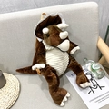 Cute brown triceratops plush backpack with adjustable yellow straps on a sofa - Brown Triceratops