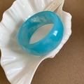Close-up of blue marble resin oval bangle on a white shell tray with high gloss finish - Sky Blue