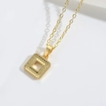 Macro shot of gold square openwork pendant with detailed round scales texture on O-chain - Square