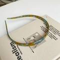 Detail of slim acetate headband with yellow and blue tortoise pattern on a book - Acetate Sheet / Marbled Blue Brown