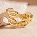 Detail of a polished gold twisted knot bangle on a minimalist stone surface - Gold Knot Horse-bit Style / Gold