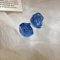 Macro view of blue crystal petal earrings with sparkling resin mineral texture and facets - Blue