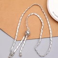 Silver metal chain interwoven with white leather featuring a spherical charm and lobster clasp - Silver White