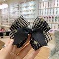 Detail of creative Halloween bow hair clip featuring star pattern mesh and black faux leather - Star Ribbon Bow Clip