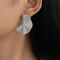 Modern silver pleated fan earrings with irregular wave design worn by female model - Gold