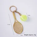 Miniature sports keychain featuring a gold tennis racket and green felt tennis ball - 2cm Small Fluorescent Green Tennis Ball + Gold Racket