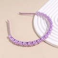 Detail of elegant purple faux pearls in various sizes on a satin wrapped headband - Purple