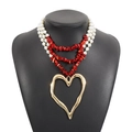 Detail of layered pearl and red turquoise necklace with a large gold heart pendant - Heart Pendant / Red + Gold