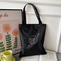 Minimalist black Oxford tote bag with cartoon sheep and heart print in a lifestyle setting - Black with Heart Sheep