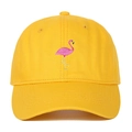 Close-up of pink flamingo embroidery on a vibrant yellow cotton baseball cap - Yellow