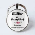 Detail of silver round keychain with Mother & Daughters floral glass cabochon - Mother & Daughter Forever Linked