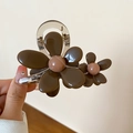 Detailed close-up of dark brown and beige resin flower hair claw clip for women - Brown