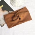 Chic caramel brown knitted headband featuring a stylish cross-knot rib-knit design - Caramel