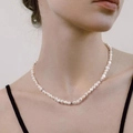 Minimalist freshwater pearl necklace with gold metal beads worn on a model's neck - White Pearl Short Choker (U-a-027)