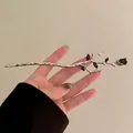 Macro view of gothic silver metal hair stick with black rose and leaf details - Silver Branch Black Bud / Silver
