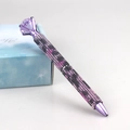 Detail of a purple leopard print pen encrusted with rhinestones and a large diamond top - Pink Leopard