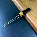 Detail of U-shaped gold hair fork with black stone and gold wire wrapping - Obsidian