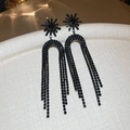 Detailed view of long black tassel earrings featuring star shape and rhinestone inlay - Gun Black Flower Style (Silver Needle)