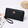Close-up of black quilted long wallet featuring gold double-ring logo and wrist strap - 19X2.5X10 / Black