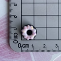 Close-up of a 1.5 cm pink resin donut charm with colorful sprinkles on a measuring mat - 08-Pink Ruffle Black Donut