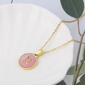 Pink shell round pendant necklace with golden letter N on a white ceramic shell tray - Pink-N