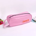 Pink waterproof travel shoe storage bag with zipper, handle and orange shoe icon - Pink