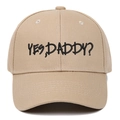 Close-up of black 'YES, DADDY?' embroidery on a khaki cotton baseball cap with fine stitching - Adjustable / Khaki
