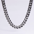Macro shot of polished stainless steel Cuban chain link necklace with high metal luster - 8mm Vintage Silver