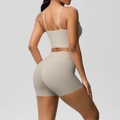Rear view of women's ribbed yoga set with racerback sports bra and high-waisted shorts - Camel Brown