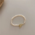 Detail of freshwater pearl bracelet with a golden OT toggle clasp on beige background - 36# Simple Buckle Pearl Bracelet